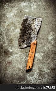 Old hatchet for cutting. On a stone background.. Old hatchet for cutting. On stone background.
