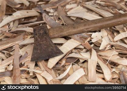 Old heavy axe tool with wood scrap