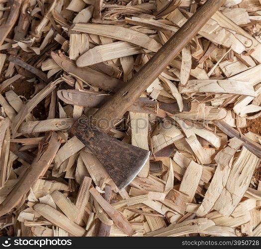 Old heavy axe tool with wood scrap