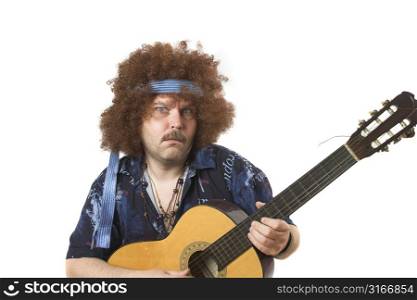 Old hippie putting on a face while playing his guitar