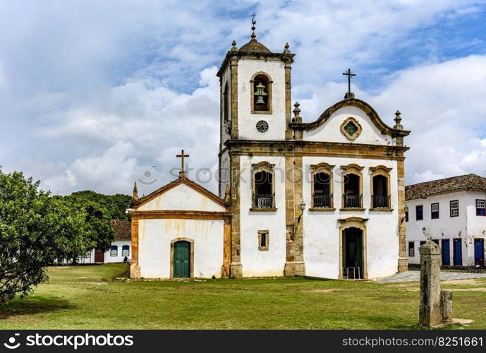 Old historic church surrounded by colonial houses in the famous and bucolic city of Paraty on the coast of Rio de Janeiro. Old historic church surrounded by colonial houses in Paraty