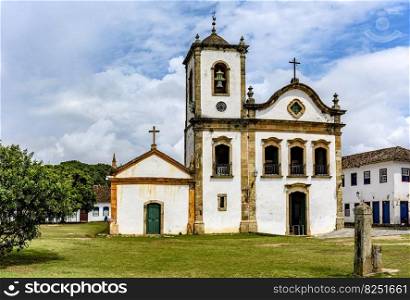 Old historic church surrounded by colonial houses in the famous and bucolic city of Paraty on the coast of Rio de Janeiro. Old historic church surrounded by colonial houses in Paraty