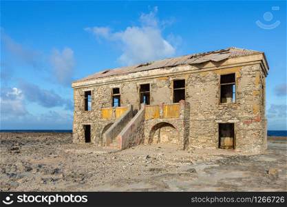 Old historic hotel building as ruin at coast of island Bonaire
