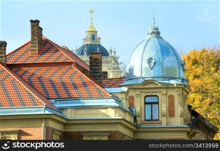 Old historical house in centre of Lviv City (Ukraine) and Saint Yuriy church cupola view behind