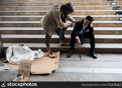 Old homeless beggar man cheer up sad businessman in city. Unemployed business man get fired due to covid-19 or coronavirus. Leave without pay, quarantine, work from home, global pandemic disease.