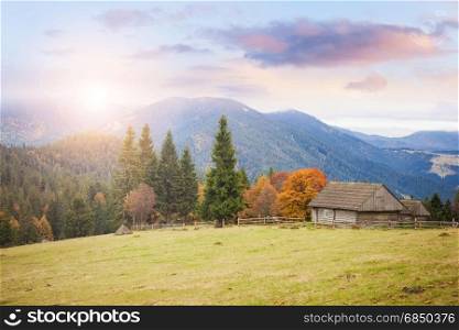 Old house at the mountain hill. Countryside farmland alpine landscape