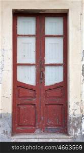 Old house with a red door weathered wood