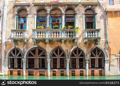 Old house with arches and balcony in Venice. Old house with arches and balcony near canal in Venice