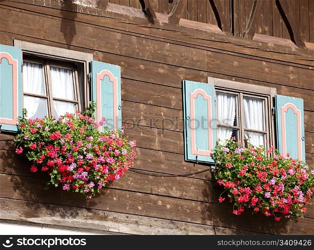 Old house with flowers on the window
