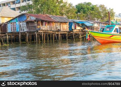 Old houses along the Chao Phraya riverside. Bangkok, Thailand.