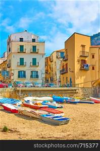 Old houses and boats on beach in Cefalu, Sicily, Italy