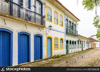 Old houses facades in colonial style on the streets of the old and historic city of Paraty founded in the 17th century on the coast of the state of Rio de Janeiro, Brazil. Old houses facades in colonial style on the old and historic city of Paraty