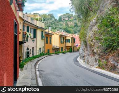 Old houses in the resort town Portofino.. Multi-colored facades of old houses along the road to Portofino. Italy. Liguria. Cinque Terre.