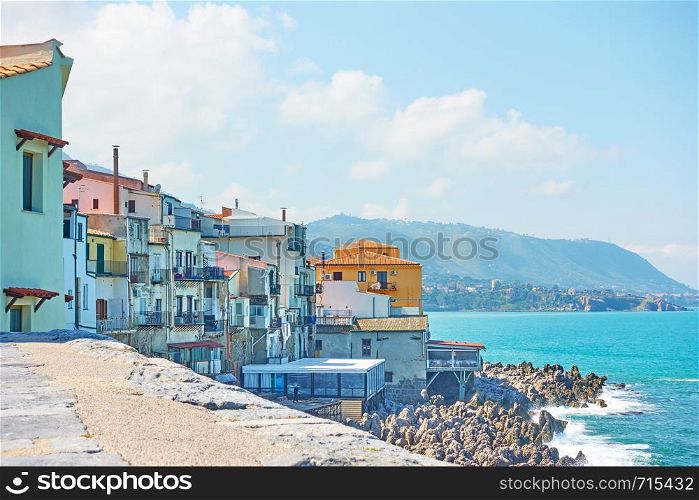 Old houses on rocky coast by the sea in Cefalu, Sicily, Italy