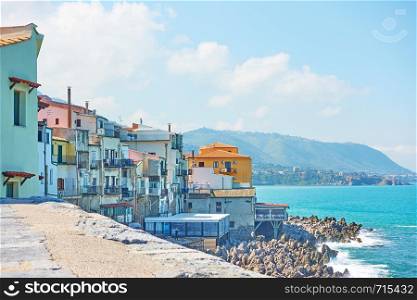 Old houses on rocky coast by the sea in Cefalu, Sicily, Italy