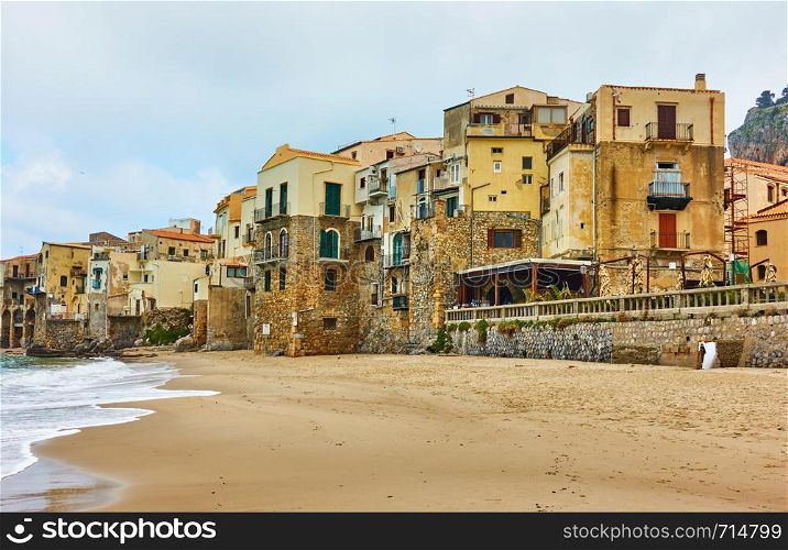 Old houses on the beach in Cefalu, Sicily, Italy