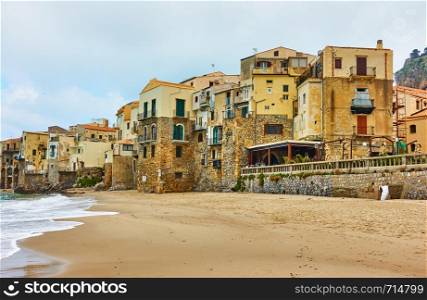 Old houses on the beach in Cefalu, Sicily, Italy