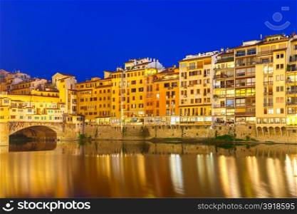 Old houses on the embankment of the River Arno and Ponte Vecchio at night, Florence, Tuscany, Italy