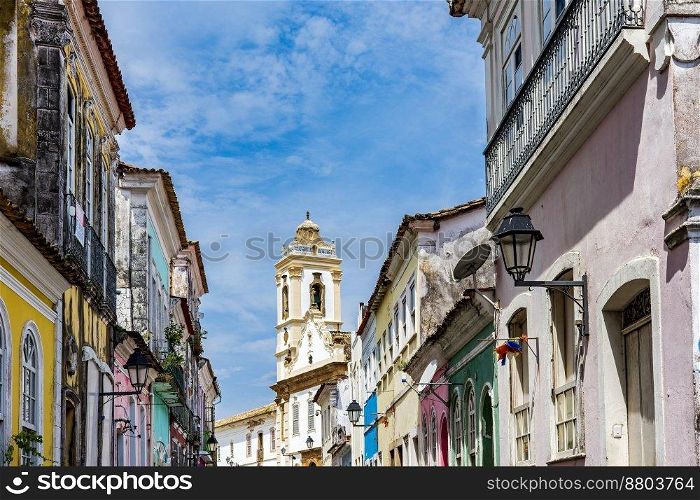 Old houses with colorful facades and historic baroque church tower in Pelourinho neighborhood in Salvador Bahia. Old houses with colorful facades and historic church tower in Pelourinho