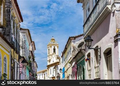 Old houses with colorful facades and historic baroque church tower in Pelourinho neighborhood in Salvador Bahia. Old houses with colorful facades and historic church tower in Pelourinho