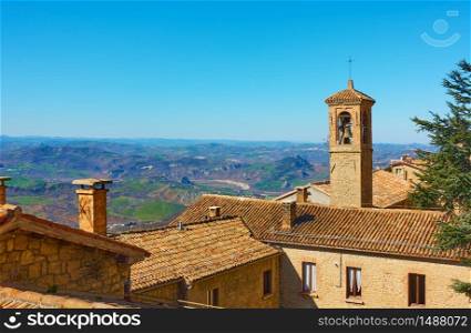 Old houses with tiled roofs and bell tower in San Marino - Landscape