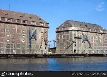 Old industrial buildings used as a granaries in the past at the Motlawa river waterfront in Gdansk, Poland