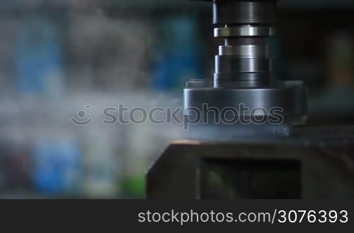 Old industrial milling machine cutting metal process by milling cutter with hardmetal carbide insert.