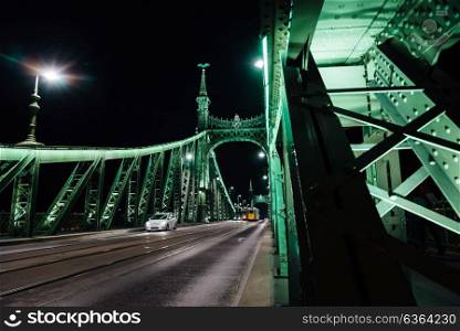 Old Iron Bridge at night in the light of streetlights across the Danube River in Budapest Hungary