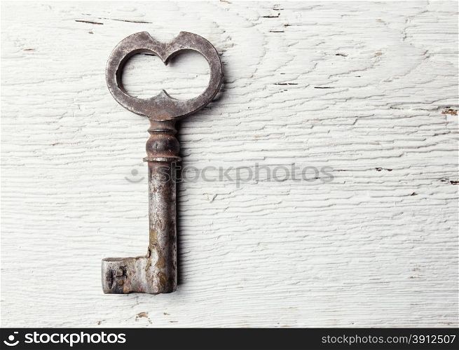Old key on wooden table