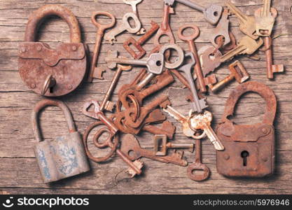 old keys locks over vintage wooden table. old keys