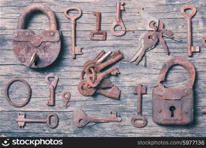 old keys locks over vintage wooden table. old keys
