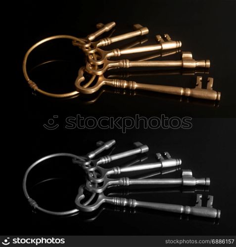 Old keys on a keyring on black background