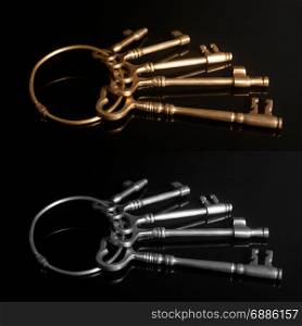 Old keys on a keyring on black background
