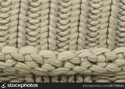 Old knit sweater background. Beige color. Studio shot