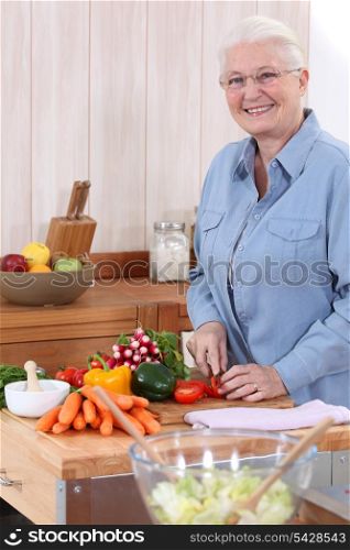 Old lady chopping vegetables