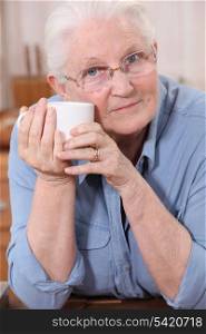 Old lady drinking from mug