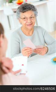 Old lady playing a card game