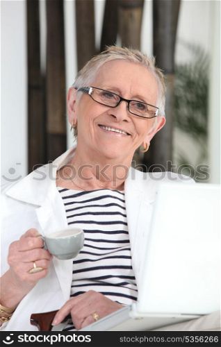 Old lady with laptop and coffee