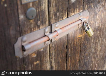 Old latch of a wooden door of a cow shed