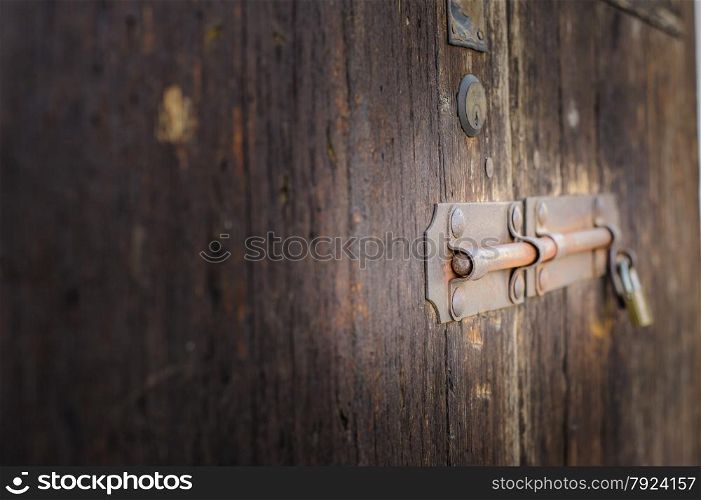 Old latch of a wooden door of a cow shed