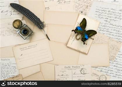 old letters, handwritings, vintage postcards and antique feather pen. nostalgic sentimental background with butterfly