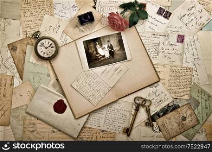 Old letters, photographs and postcards. Nostalgic vintage wedding background. Retro style toned picture