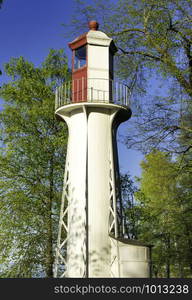 Old lighthouse on the coast of the Gulf of Finland. Old lighthouse among the trees