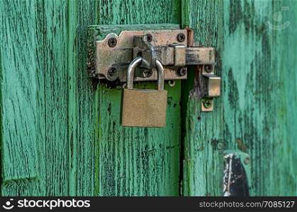 Old lock on a weathered door. Texture background.