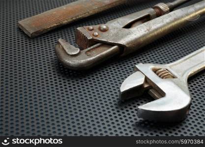 Old locksmith tools on a dark metallic background