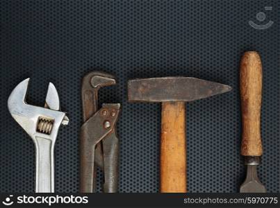 Old locksmith tools on a dark metallic background