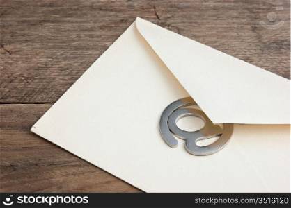 old mailing envelope and sign the e-mail on a wooden background