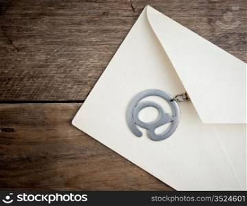 old mailing envelope and sign the e-mail on a wooden background