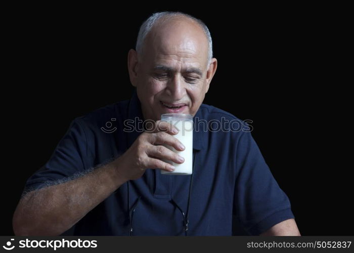 Old man drinking glass of milk