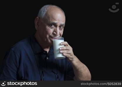 Old man drinking glass of milk